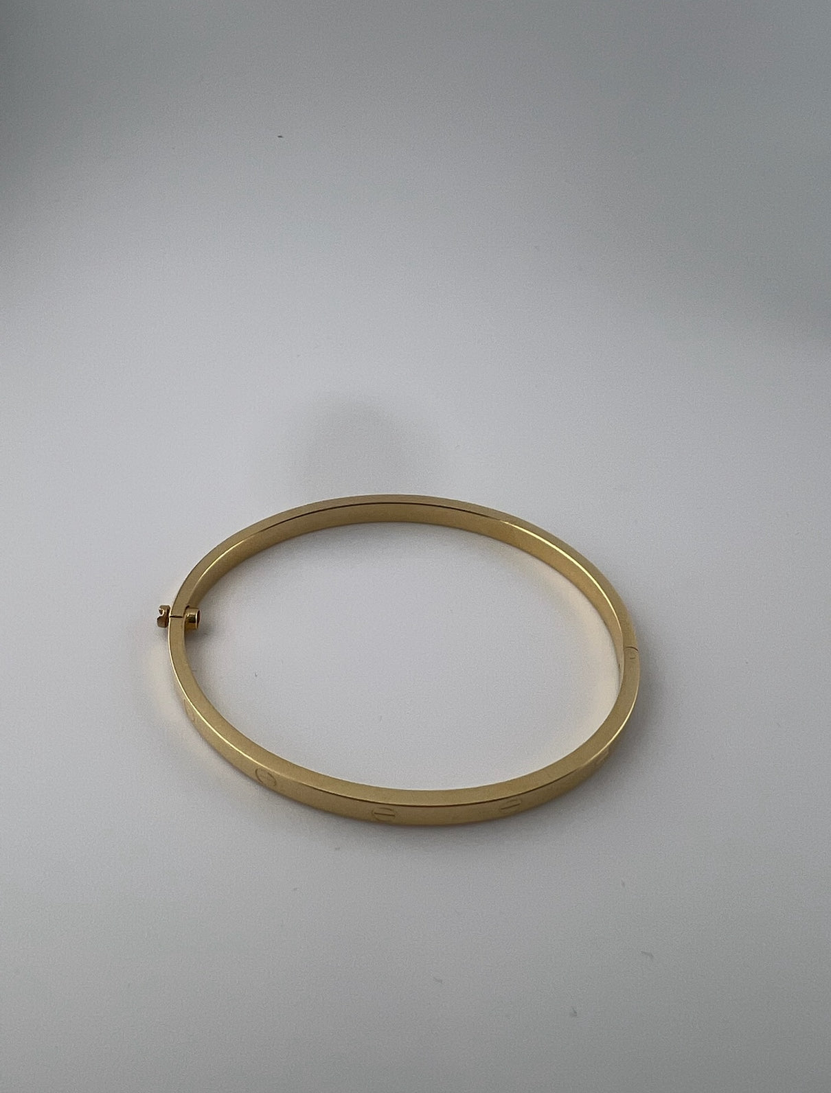 Thin hollow bangle, 18k gold, opens with a screw