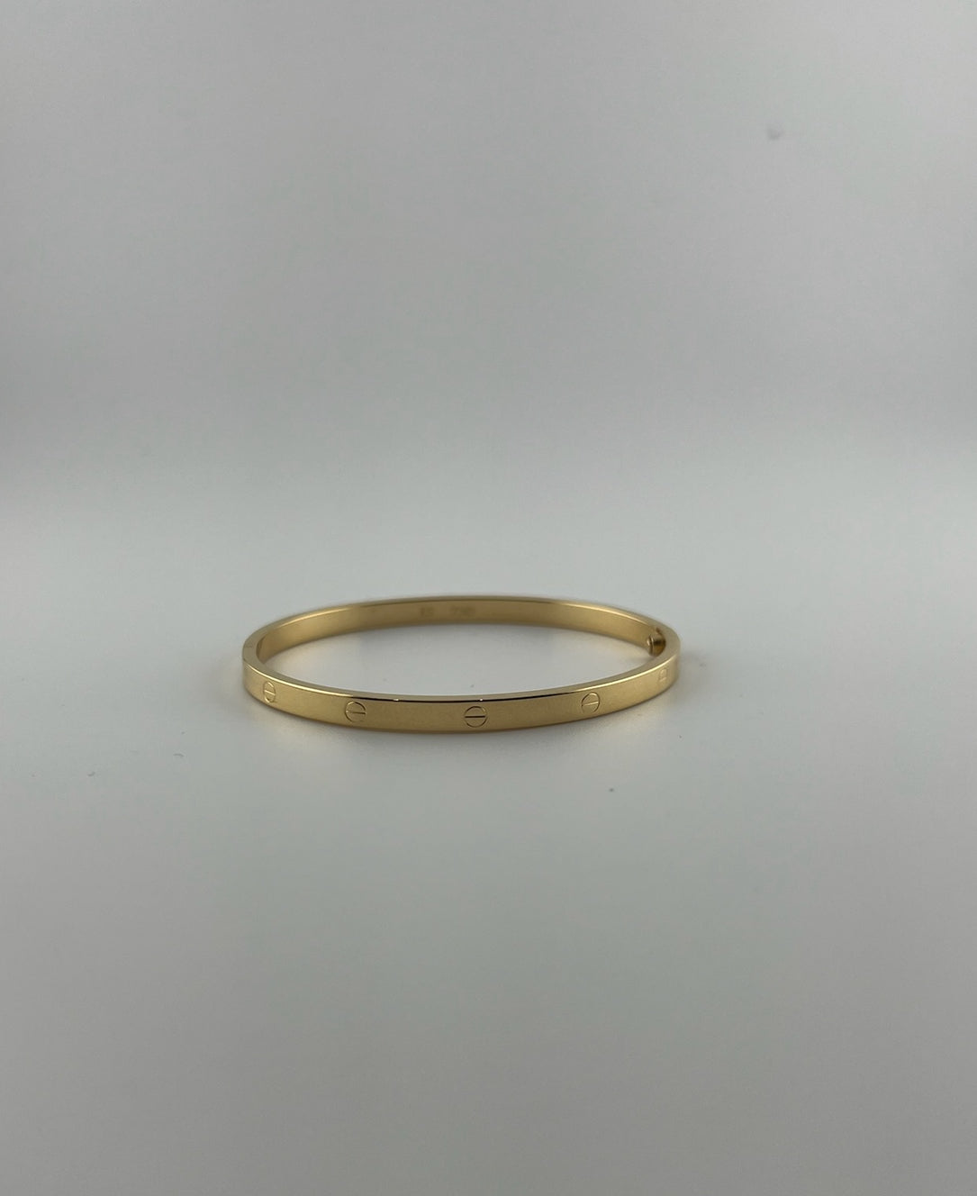Thin hollow bangle, 18k gold, opens with a screw