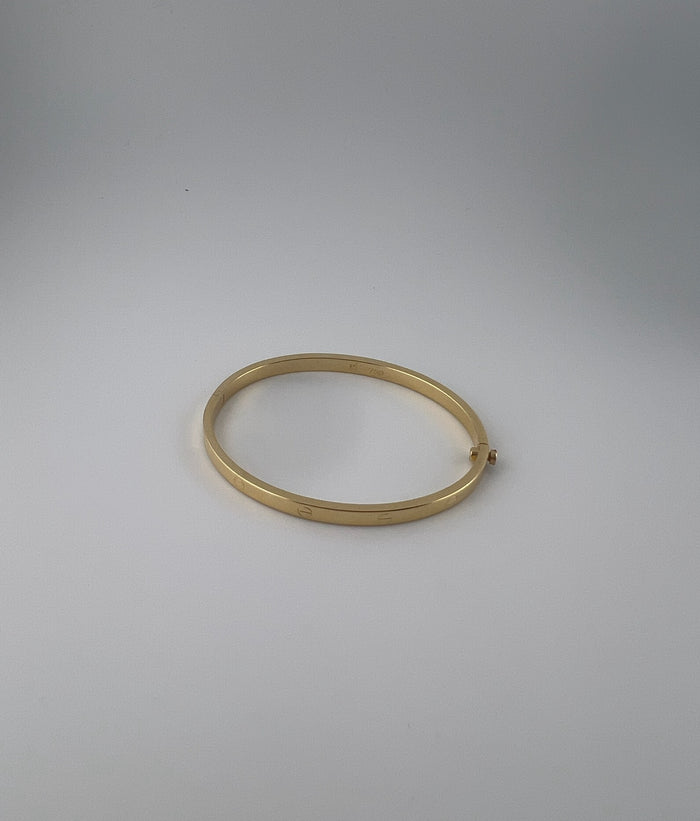 Thin hollow bangle, 18k gold, opens with a screw