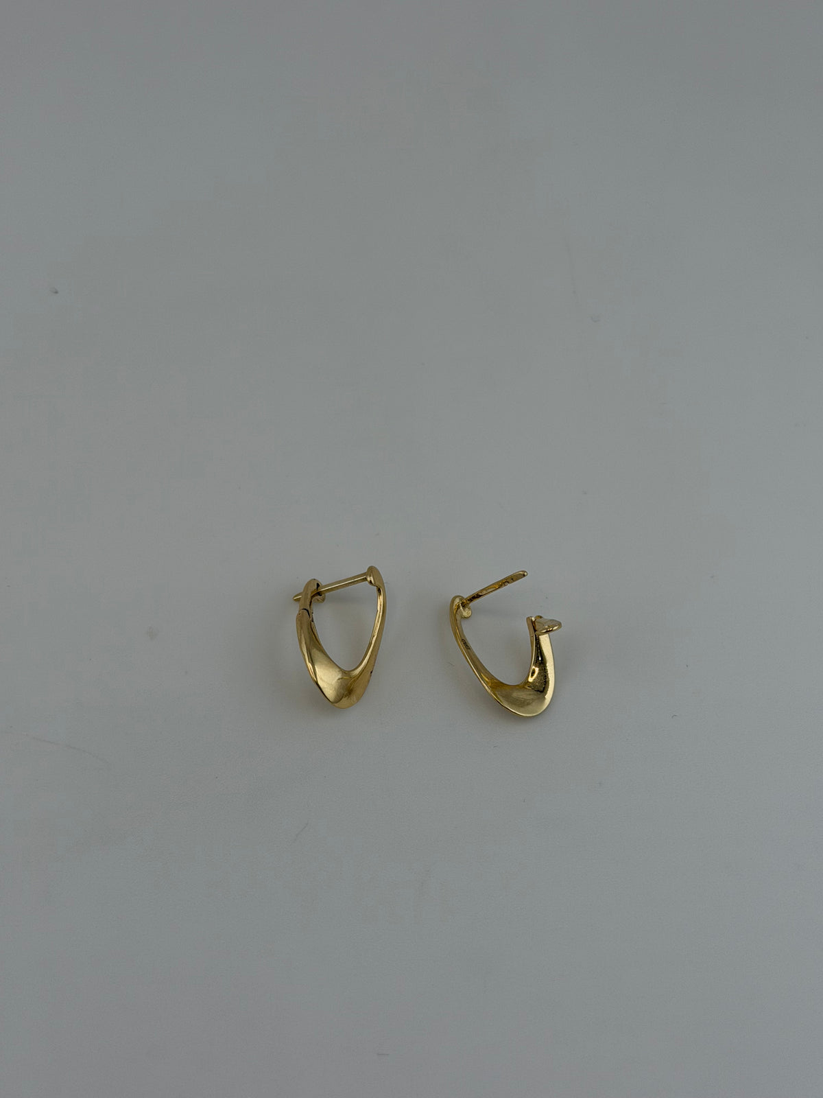 18K Solid Gold Sculpted Wave Huggie Earrings - Image 1