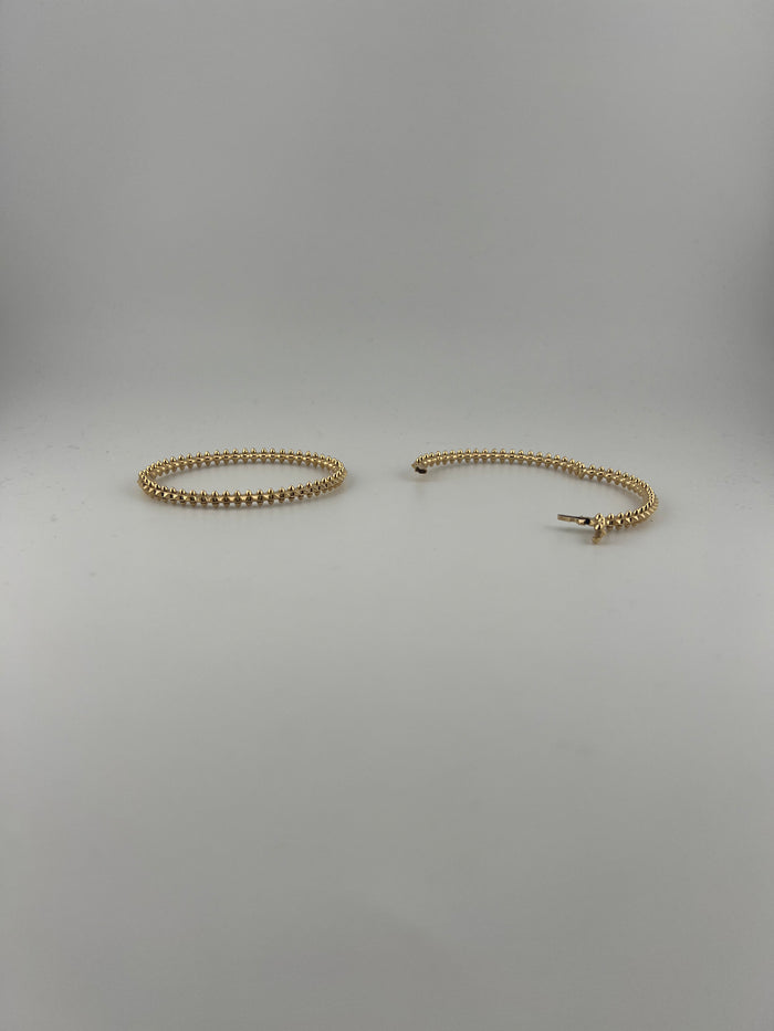 Semi-solid 18k yellow gold bangle with spikes