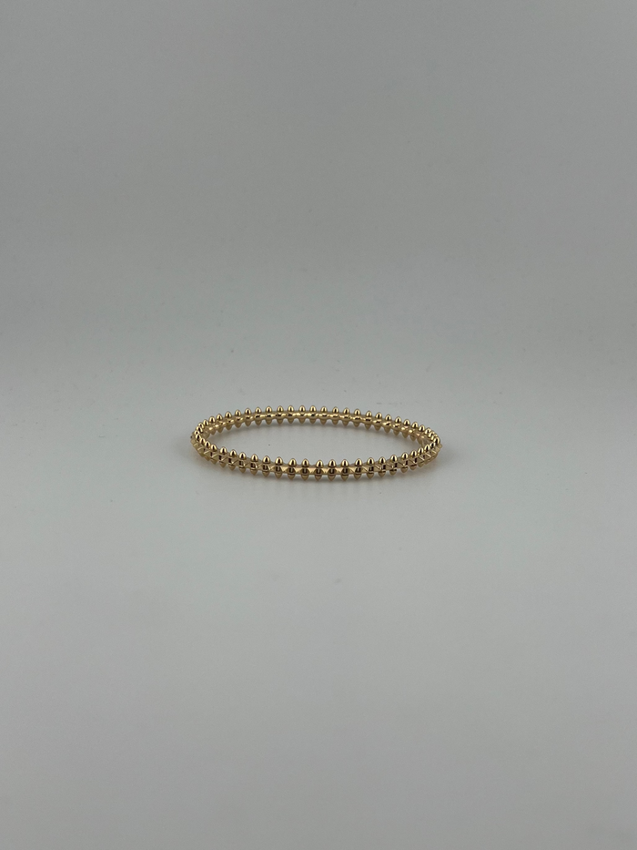 Semi-solid 18k yellow gold bangle with spikes