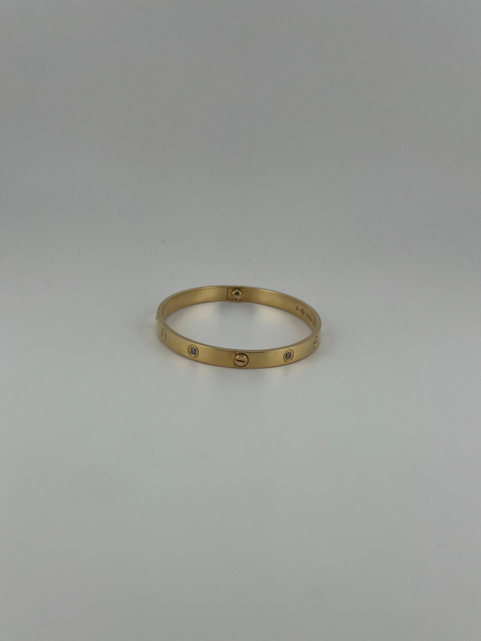 Two screws 18k yellow gold CZ six-stone bangle with screw markings